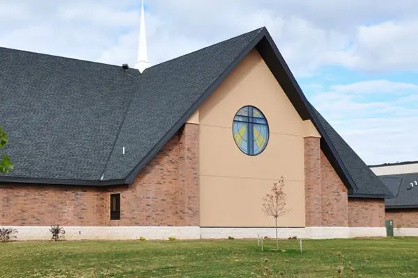 A church with a cross on the side of it.