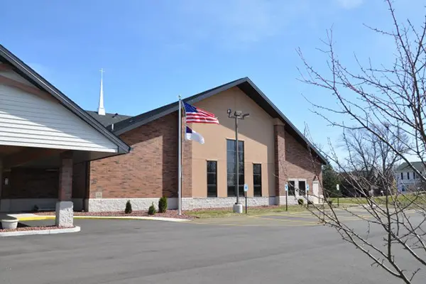 A church with a flag flying in front of it.