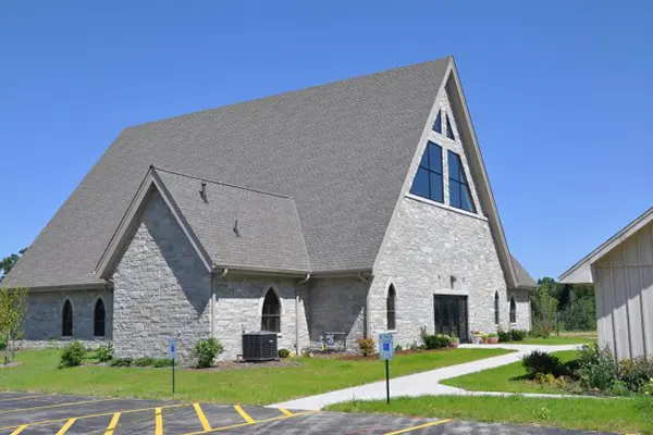A church with a large building on the side of it.