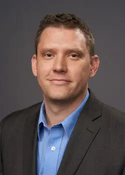 A man in a suit and blue shirt